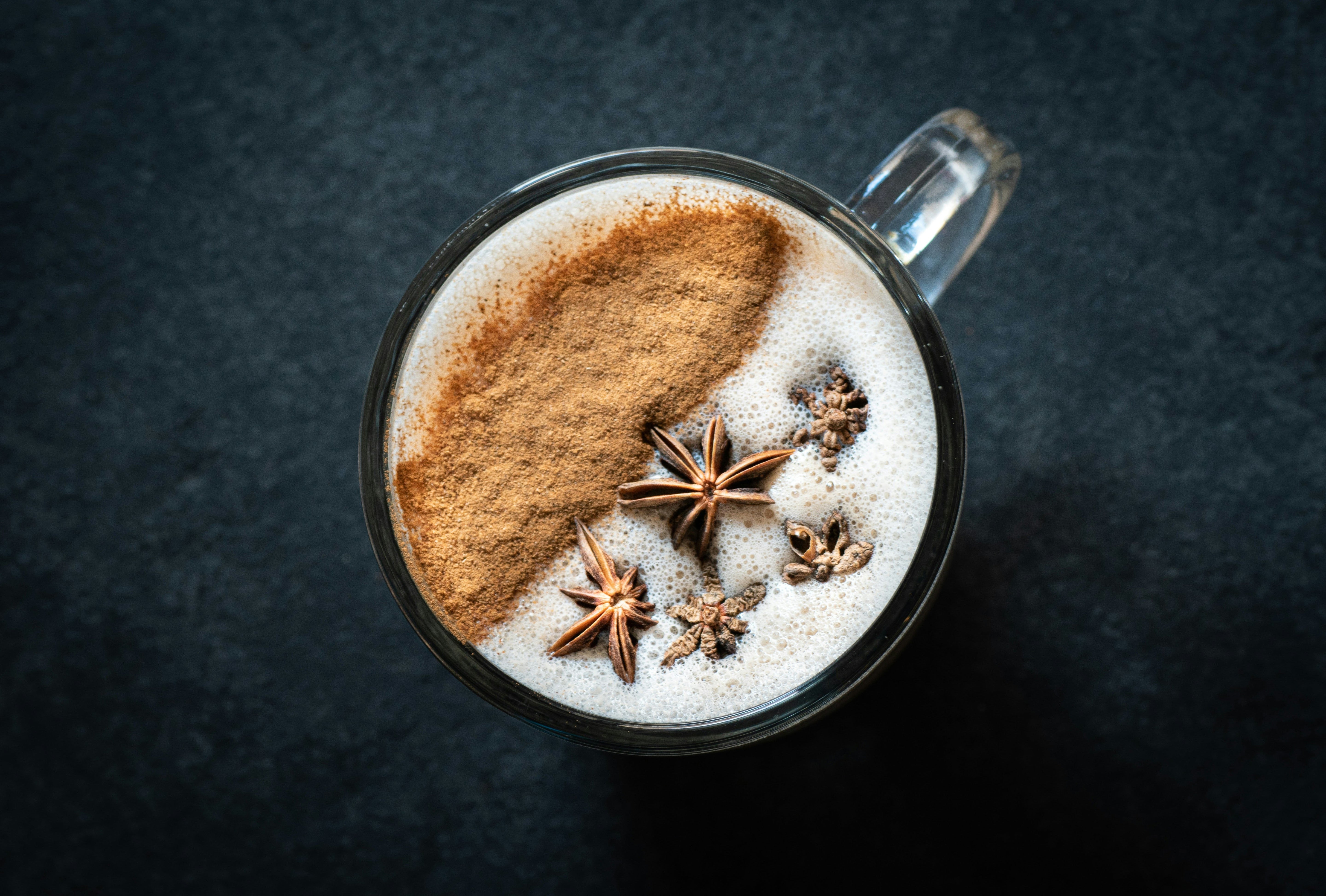Overhead view of a specialty blended coffee latte topped with cinnamon and star anise at Wonder Waves Coffee