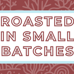Text 'Roasted in Small Batches' on a white background, surrounded by a soft blue frame and a subtle crimson brown coral-themed backdrop, highlighting the artisan and small-batch roasting process for specialty coffee