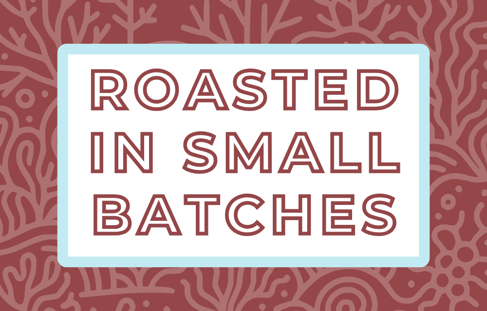 Text 'Roasted in Small Batches' on a white background, surrounded by a soft blue frame and a subtle crimson brown coral-themed backdrop, highlighting the artisan and small-batch roasting process for specialty coffee
