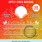 Sunset Spice Apple Cider Rooibos tea packaging featuring a naturally caffeine-free herbal blend with spicy, sweet, and balanced notes. A vibrant red and orange design with a sunset illustration, promoting ocean-friendly values and perfect for year-round enjoyment hot or iced.