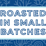 Text 'Roasted in Small Batches' on a white background, surrounded by a soft blue frame and a subtle ocean blue coral-themed backdrop, highlighting the artisan and small-batch roasting process for specialty coffee