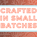 Text 'Crafted in Small Batches' on a white background, surrounded by a soft blue frame and a coral-toned and coral-themed backdrop, highlighting the artisan and small-batch blending process for artisan tea