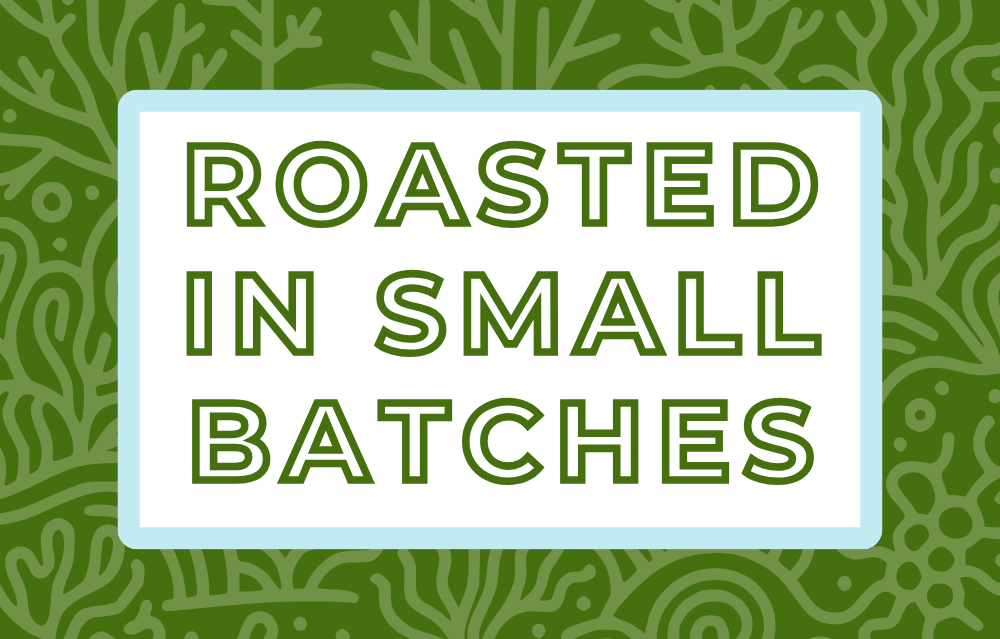 Text 'Roasted in Small Batches' on a white background, surrounded by a soft blue frame and a subtle lush green coral-themed backdrop, highlighting the artisan and small-batch roasting process for specialty coffee