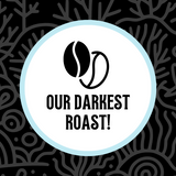 Stylized coffee bean icon above the text “Our Darkest Roast!” set on a deep black coral-inspired background, emphasizing bold, rich flavor