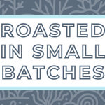 Text 'Roasted in Small Batches' on a white background, surrounded by a soft blue frame and a subtle grayish blue coral-themed backdrop, highlighting the artisan and small-batch roasting process for specialty coffee