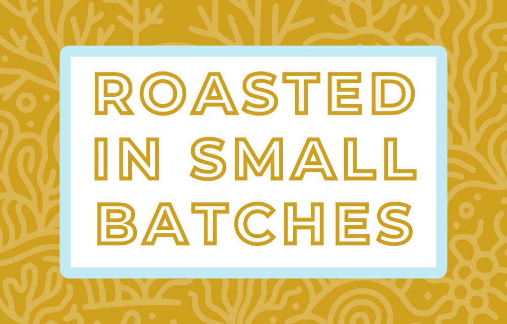 Text 'Roasted in Small Batches' on a white background, surrounded by a soft blue frame and a subtle honey yellow coral-themed backdrop, highlighting the artisan and small-batch roasting process for specialty coffee