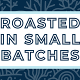 Text 'Roasted in Small Batches' on a white background, surrounded by a soft blue frame and a subtle midnight blue coral-themed backdrop, highlighting the artisan and small-batch roasting process for specialty coffee