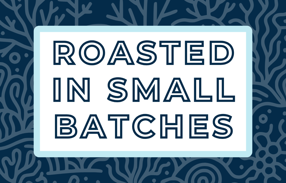 Text 'Roasted in Small Batches' on a white background, surrounded by a soft blue frame and a subtle midnight blue coral-themed backdrop, highlighting the artisan and small-batch roasting process for specialty coffee