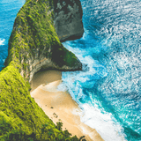 A breathtaking view of Bali’s tropical coastline with turquoise waters and lush green cliffs, inspiring the rich, vibrant flavors of Bali Blue coffee, a smooth single-origin roast.