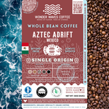 Aztec Adrift Mexico coffee packaging featuring a medium roast with medium acidity and creamy body. Flavor notes include lemon, brown sugar, and dark chocolate. Sourced from the Chiapas region at 1,200–1,900 MASL. Includes icons for whole bean and eco-conscious packaging with a clean ocean design and sustainability logos for CleanHub, World Coffee Research, and 1% for the Planet.