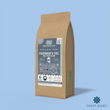 Fisherman’s Fuel Post-Roast Blend whole bean coffee packaging with a rustic kraft bag design, featuring a blue ocean-themed label with a fisherman illustration, coffee roast icons, and the ‘Craft Blend’ label. Includes branding for Wonder Waves Coffee, emphasizing its medium-dark roast and eco-friendly packaging.