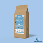 Pacific Pearl Peru whole bean coffee packaging with a rustic kraft bag design, featuring a soft blue ocean-themed label with a seashell illustration, coffee roast icons, and the ‘Single Origin’ label. Includes branding for Wonder Waves Coffee, emphasizing its medium roast and eco-friendly packaging.