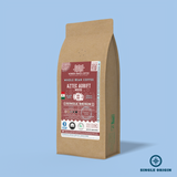 Aztec Adrift Mexico whole bean coffee packaging with a rustic kraft bag design, featuring a deep red ocean-themed label with an Aztec glyph illustration, coffee roast icons, and the 'Single Origin' label. Includes branding for Wonder Waves Coffee, emphasizing its medium roast and eco-friendly packaging.
