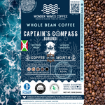 Captain’s Compass Burundi coffee packaging featuring a light-medium roast with bright acidity and silky body. Flavor notes include dried fig, zesty lemon, and sweet caramel. Sourced from the Kayanza Province at 1,900 MASL. Includes icons for whole bean and eco-conscious packaging with a clean ocean design and sustainability logos for CleanHub, World Coffee Research, and 1% for the Planet. Marked as Coffee of the Month for September 2025.