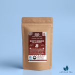 Mighty Monarch English Breakfast Tea packaging with a rustic kraft pouch design, featuring a maroon ocean-themed label with an illustration of a galleon, flavor descriptors, and the ‘Artisan Tea’ label. Includes branding for Wonder Waves Coffee, emphasizing its robust, malty, and brisk profile and eco-friendly packaging.