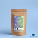 Gulfstream Glow Jasmine Green Tea packaging with a rustic kraft pouch design, featuring a gradient purple-to-green ocean-themed label with jellyfish illustrations, flavor descriptors, and the ‘Artisan Tea’ label. Includes branding for Wonder Waves Coffee, emphasizing its crisp, floral, and earthy profile and eco-friendly packaging.