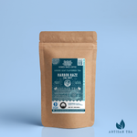 Harbor Haze Earl Grey black tea packaging with a rustic kraft pouch design, featuring a deep teal ocean-themed label with a lighthouse illustration, flavor descriptors, and the ‘Artisan Tea’ label. Includes branding for Wonder Waves Coffee, highlighting its bright, aromatic, and refined character and eco-conscious packaging.