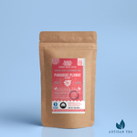 Paradise Plunge Peach black tea packaging with a rustic kraft pouch design, featuring a coral-pink ocean-themed label with a floral burst illustration, flavor notes, and the ‘Artisan Tea’ label. Includes branding for Wonder Waves Coffee, highlighting its rosy, sweet, and mild character and eco-conscious packaging.
