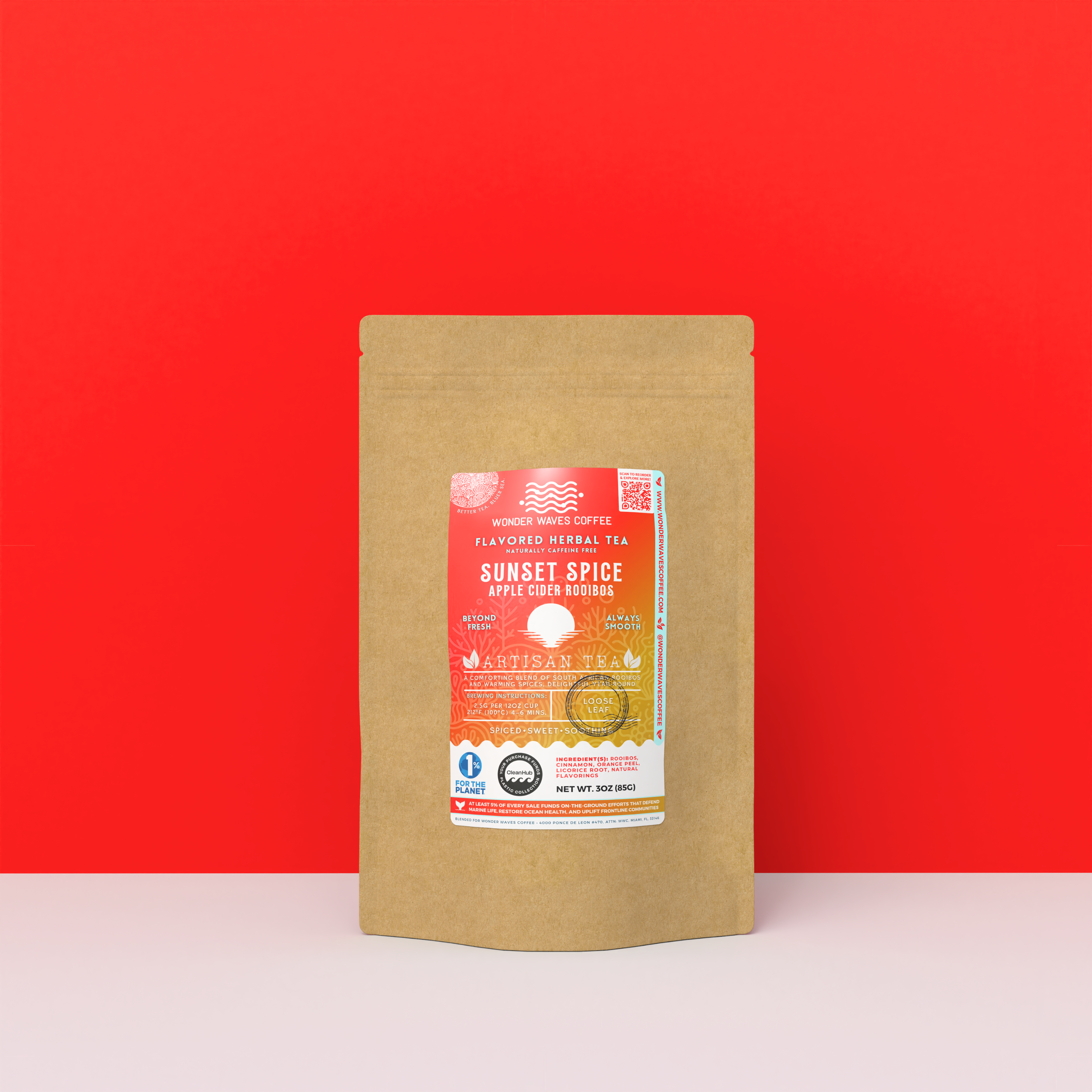 Sunset Spice Apple Cider Rooibos tea packaging with a rustic kraft pouch design, featuring a vivid red-orange ocean-themed label with a sunset illustration, flavor descriptors, and the ‘Artisan Tea’ label. Includes branding for Wonder Waves Coffee, highlighting its spicy, sweet, balanced, and caffeine-free character and eco-friendly packaging.