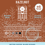 Seabreeze Sizzle Hazelnut coffee packaging showcasing a medium roast signature blend infused with roasted hazelnut flavor. Perfect hot or iced, with eco-friendly branding supporting cleaner oceans.