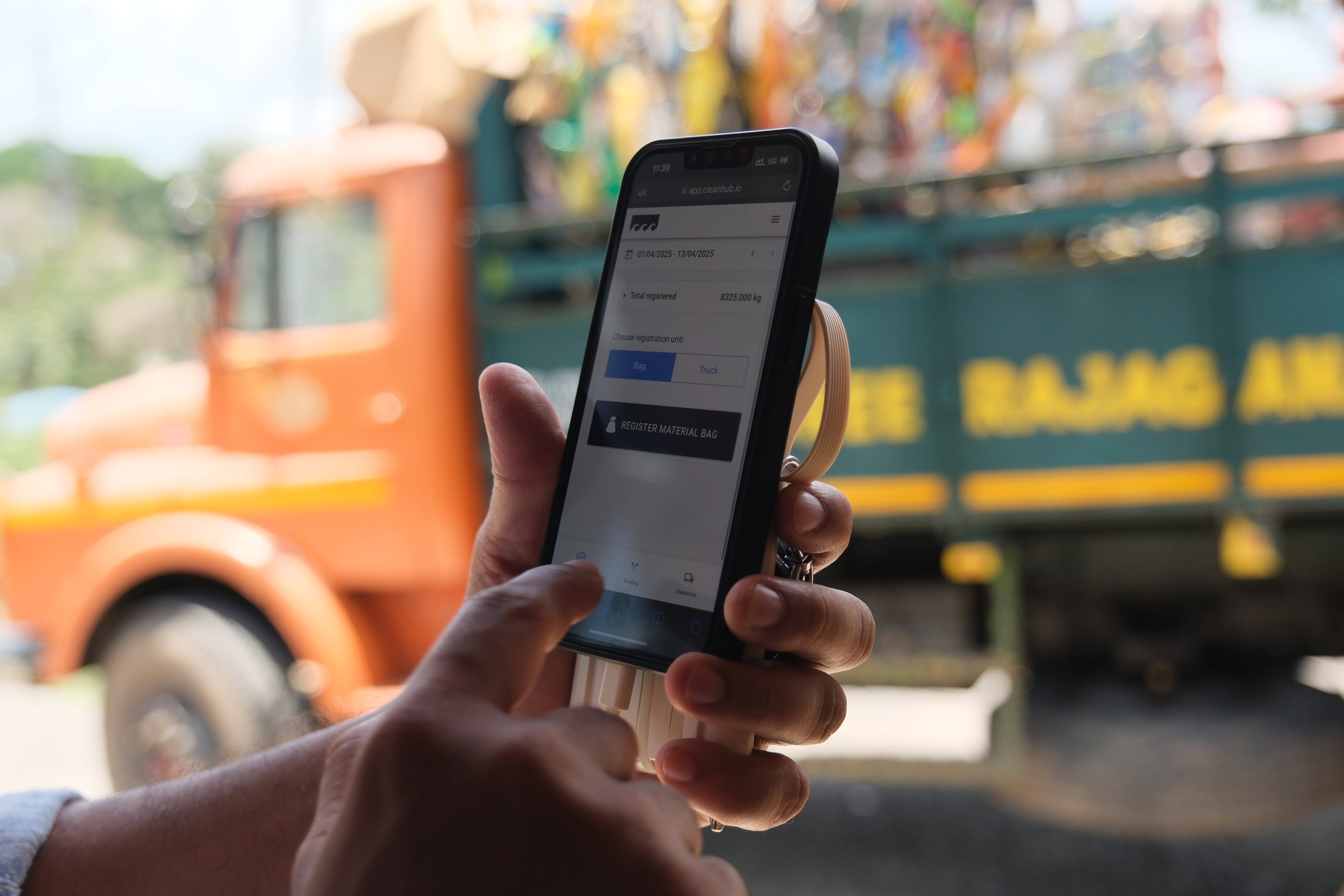 CleanHub collection partner logging verified ocean-bound plastic recovery data on the app at a collection site, representing Wonder Waves Coffee's transparent and measurable environmental impact