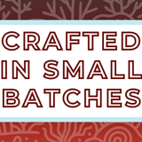 Text 'Crafted in Small Batches' on a white background, surrounded by a soft blue frame and a deep red coral-themed backdrop, highlighting the artisan and small-batch blending process for artisan tea