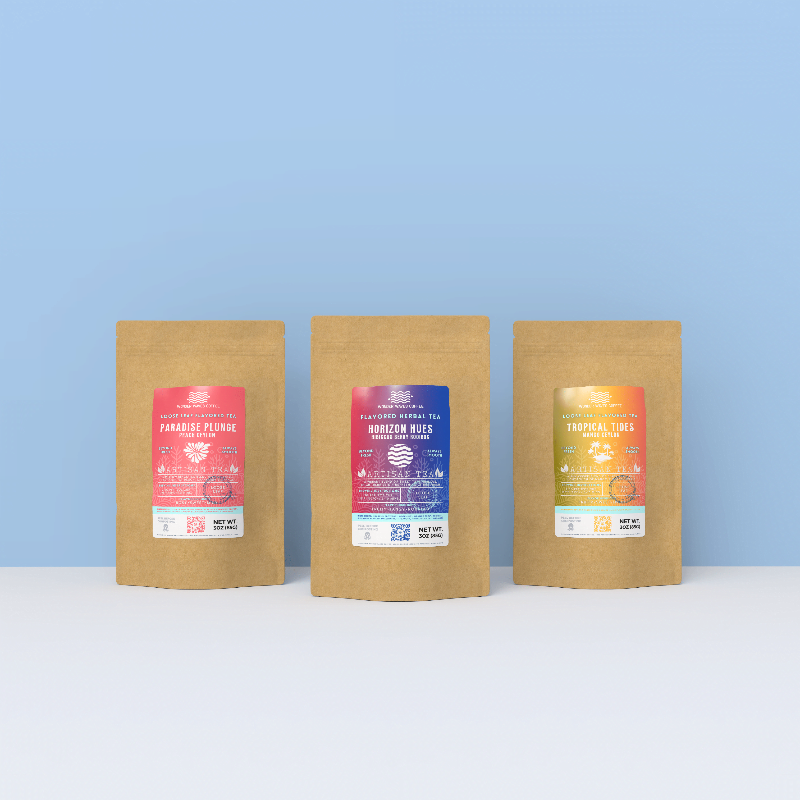 Display of three Wonder Waves Coffee artisan tea bags: paradise plunge peach Ceylon, horizon hues hibiscus berry rooibos flavored herbal tea, and tropical tides mango Ceylon, standing in a line against a light blue background.