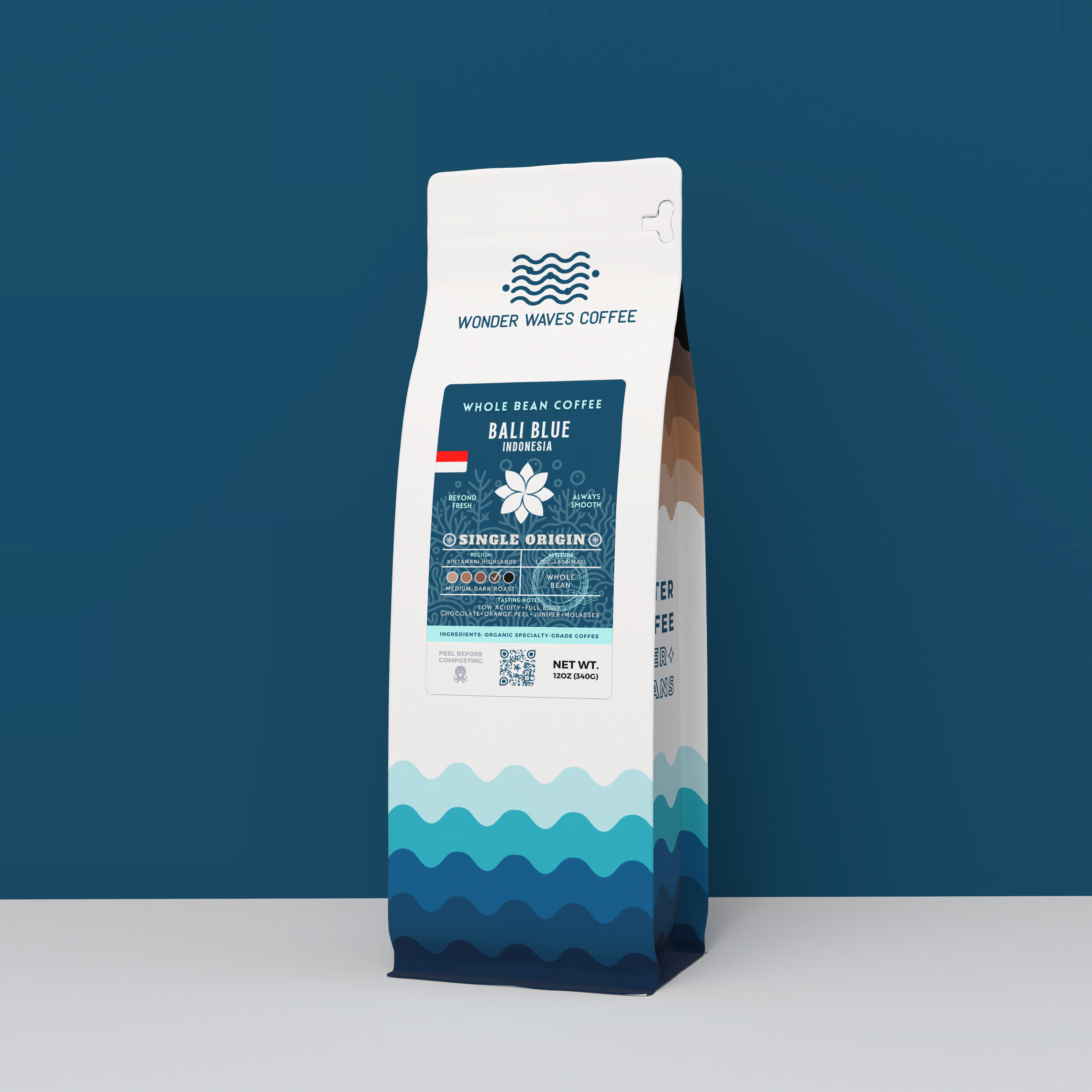 Wonder Waves Coffee Bali Blue Indonesia 12oz bag. A single origin medium-dark roast coffee featuring a deep navy ocean design and floral compass icon.