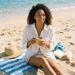 Woman enjoying Wonder Waves Coffee hazelnut coffee on a sunny beach, capturing the smooth, comforting and lightly sweet character of Seabreeze Sizzle flavored coffee.