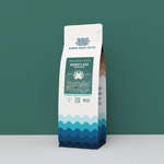 Wonder Waves Coffee Kraken’s Kiss African Blend 12oz bag, featuring a medium-dark roast whole bean coffee with a teal ocean-themed design and octopus logo.