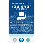 Coffee label for "Ocean Odyssey" House Espresso, a dark roast whole bean craft blend. The label features a white Viking ship illustration on a navy blue coral background. Flavor highlights are listed as rich, bold, and rounded.