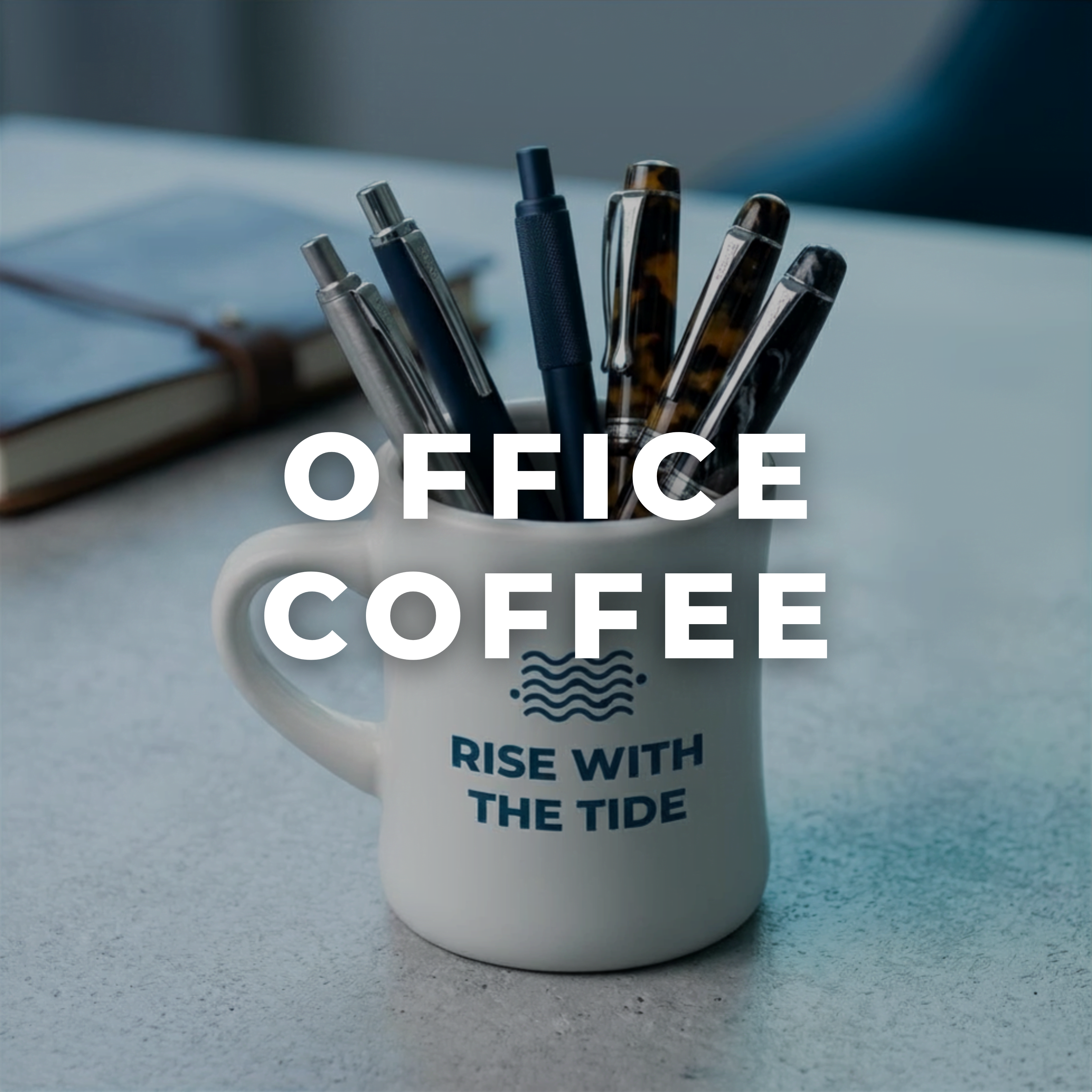 Wonder Waves Coffee Rise With The Tide ceramic mug holding assorted pens on a desk, representing the Wonder Waves office coffee collection